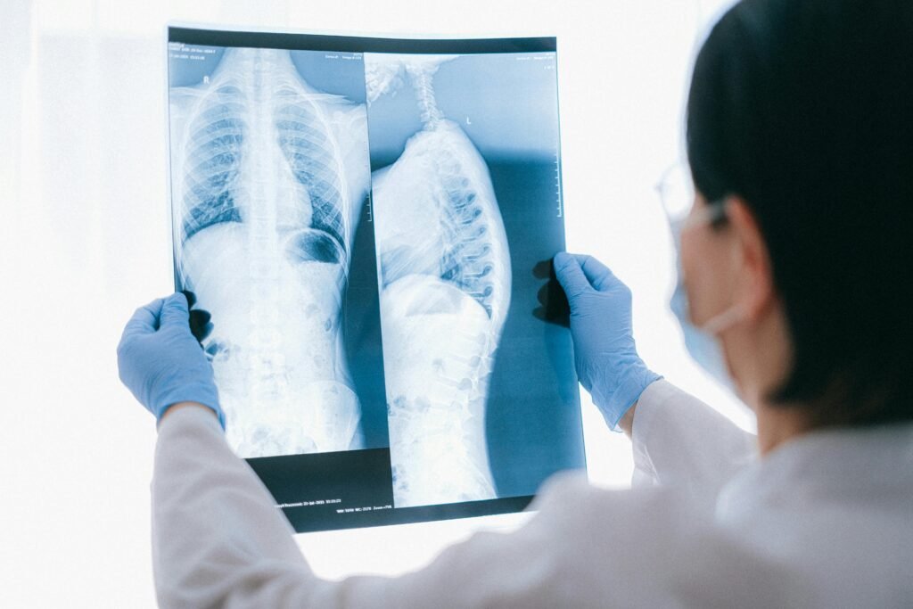Medical professional analyzing chest x-ray images in a clinical setting for diagnostic purposes.